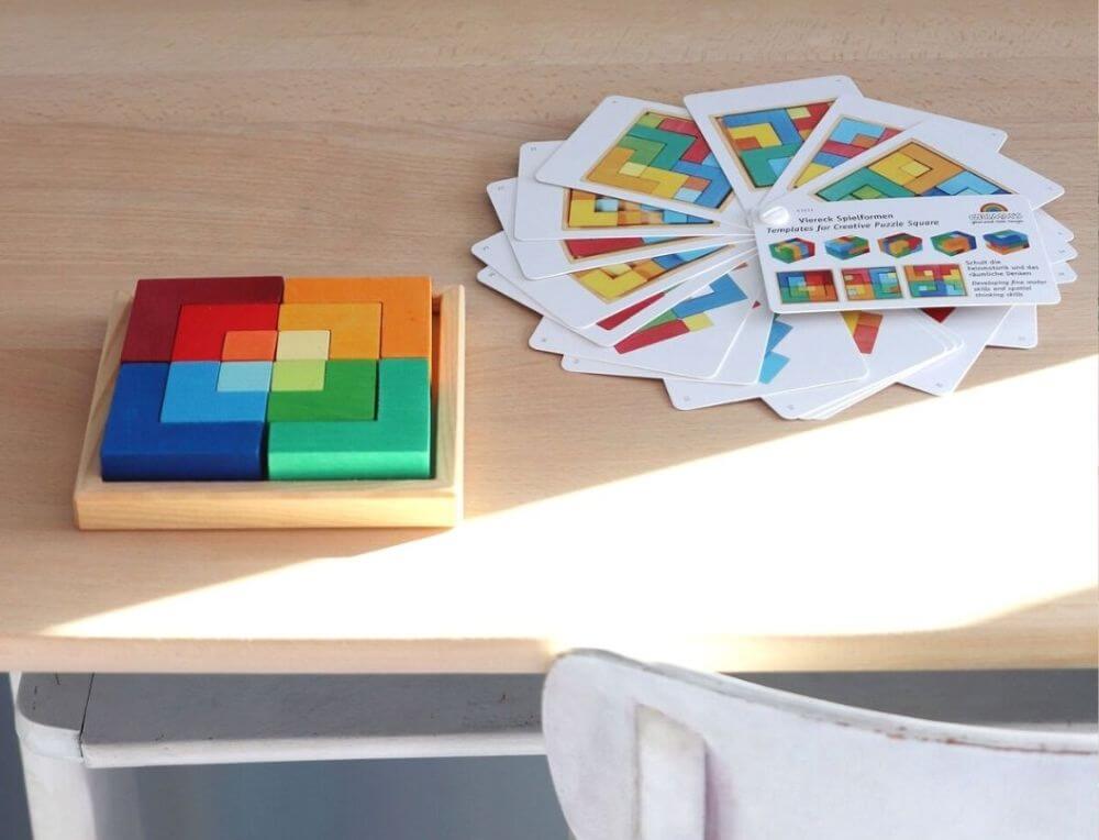 Grimm's puzzle square on a desk in a Steiner classroom with booklet of challenges