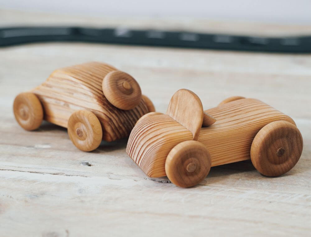 Wooden toy cars on a natural surface
